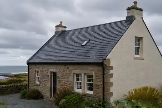 Coastal Scottish slate-roofed property in overcast weather